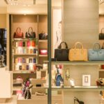 Chic boutique with a variety of handbags and shoes elegantly displayed on shelves.