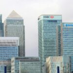 Modern skyline of Canary Wharf featuring iconic bank skyscrapers like HSBC and Barclays.